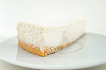 Cheesecake slice, New York style classical cheese cake. Slice of tasty cake on white plate 