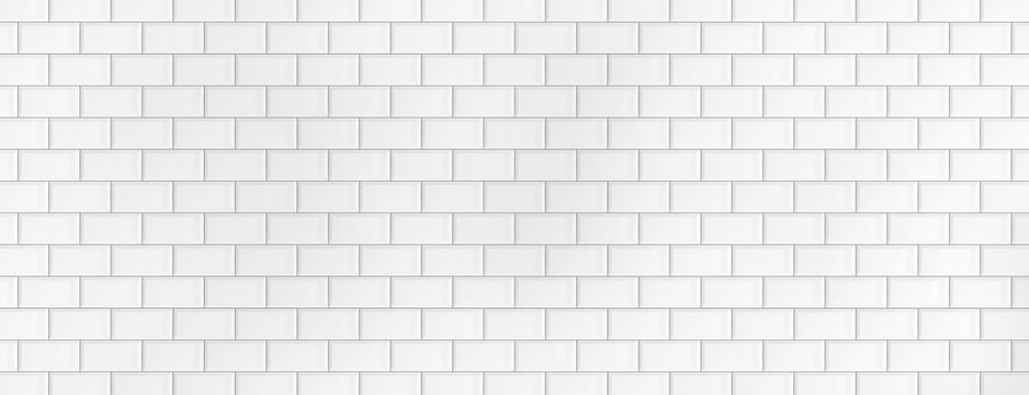 Wall made of white ceramic tiles. Background and texture. Large wide background for a banner. Tiles laid on a brick. Bright lit background.