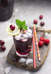 cold cherry tea with mint and lemon. soft drink with berries free space for text