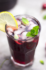 cold cherry tea with mint and lemon. soft drink with berries free space for text