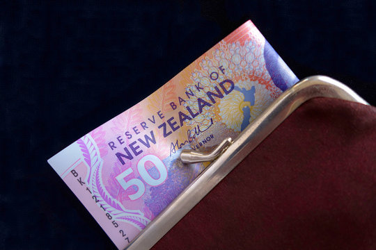 New Zealand dollars in a red purse.