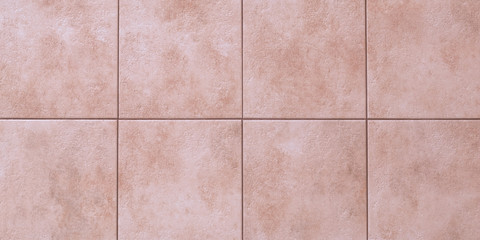Floor tiles texture, abstract pattern of squares with pink ceramic tile. Marble wall background, wallpaper. Light brown wide panorama. Great bathroom design, kitchen decoration.