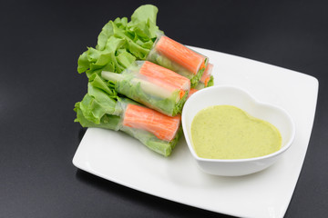 Crab stick salad rolls placed on a white plate