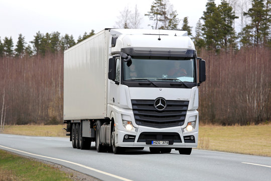 White Mercedes-Benz Actros Semi Truck on Spring Road.  Illustrative Editorial Content. 