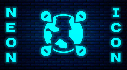 Glowing neon Location on the globe icon isolated on brick wall background. World or Earth sign. Vector.