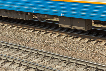 blue passenger train moving fast