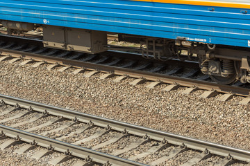 blue passenger train moving fast