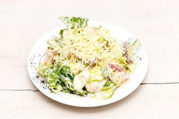 vegetable cabbage salad with mayonnaise and cheese, eggs on the table