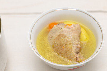 chicken soup on a white table