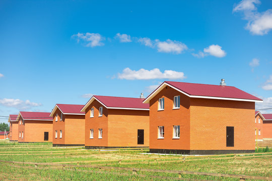 new cottage settlement. a row of newly built two-story houses. concept of construction of low-rise buildings