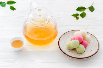 Japanese food background with sweets and tea. Three colored dumplings Dango