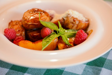 Beautiful juicy steak of marbled meat with raspberry sauce and seasonings.