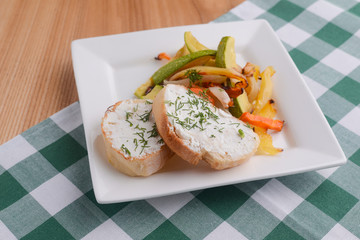 Bruschetta with cream cheese and fresh dill. Traditional Italian dish, tasty meal. Fried potatoes with vegetables.