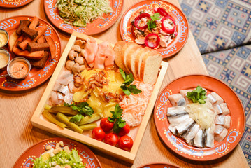 Covered table with traditional Ukrainian food, side view, horizontal. Traditional cuisine, birthday party, celebration.