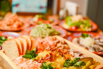 Covered table with traditional Ukrainian food, side view, horizontal. Traditional cuisine, birthday party, celebration.