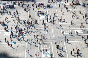 Crowd small figures of people on Piazza del Duomo square, Milan, Italy