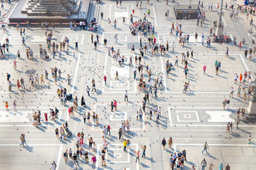 Crowd small figures of people on Piazza del Duomo square, Milan, Italy