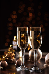 selective focus of glasses full of champagne against christmas lights