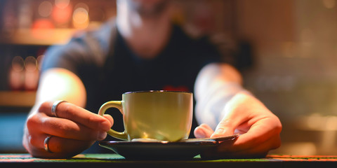 Barista making coffee in a cafe or bar. Barista in uniform at work. Art of making coffee.