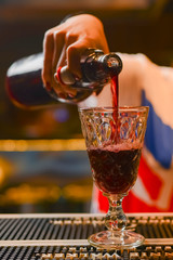 Pro barman preparing coctail drinks and serving. Representing nightlife and party event concept. Seasonal alcohol drink.