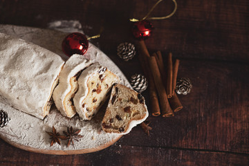 Traditional German Christmas cake - Cranberry Stollen, Christmas tree, ornaments, and candles.