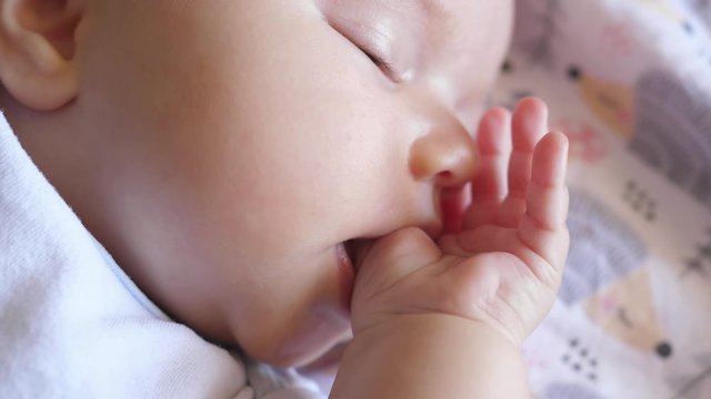 hungry little baby infant newborn toddler sucking finger thumb sleeping