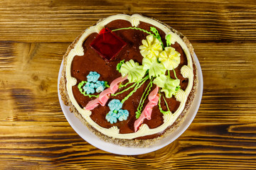 Kiev cake with cream, nuts and meringue on wooden table. Top view