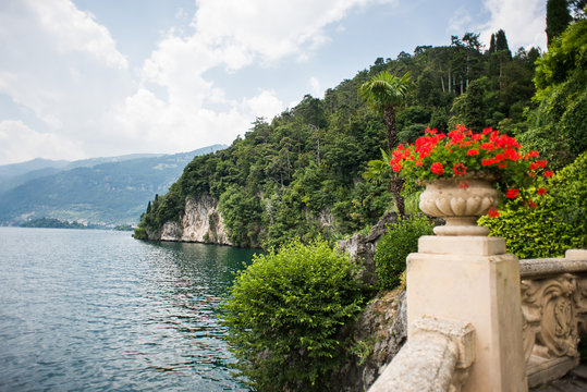 Villa Balbianello. Lake Como. Italy - July 19, 2019: Stunning Landscape on Lake Como. Italy. Stone Vase with Flowers in the Park of Villa del Balbianello.
