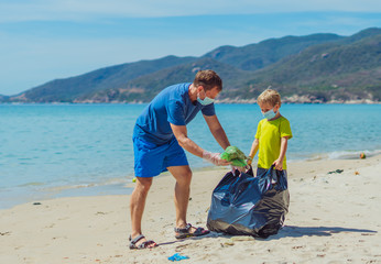 Volunteers blue face mask paradise beach sand lazur sea. Father son pick up garbage into black bag....