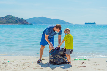 Volunteers blue face mask paradise beach sand lazur sea. Father son pick up garbage into black bag....