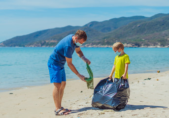 Volunteers blue face mask paradise beach sand lazur sea. Father son pick up garbage into black bag....