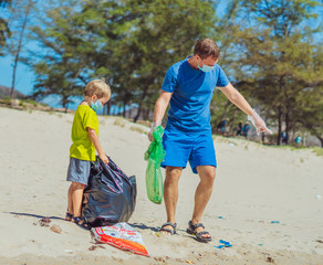 Volunteer blue face mask forest sand beach. Son helps father hold black bag for pick up garbage....