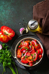 Summer Vegetable salad with fresh tomato, onion and olive oil. Healthy food. Top view flat lay. Copy space.