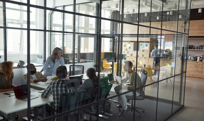 Business meeting. Group of happy smiling multiracial business people discussing project, working...
