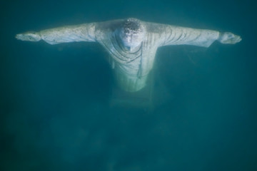 jesus statue from above while diving in a lake
