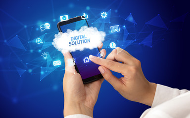 Female hand holding smartphone with DIGITAL SOLUTION inscription, cloud technology concept