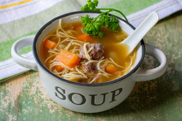 A bowl of noodle soup with beef meat 