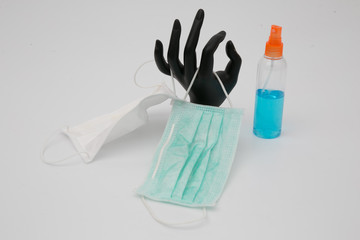 Medical masks and  hand sanitizer on white background.