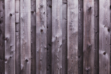 Fragment of a gray wooden fence. Wooden texture background.