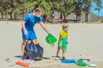 Volunteer blue face mask forest sand beach. Son helps father hold black bag for pick up garbage....