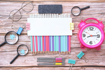 Back to school. Concept with stationery supplies for the school on wood background