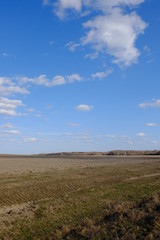 Beautiful cloudy sky over farmland. Spring landscape.
