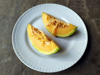 fresh healthy yellow fruit bite put in a white plate