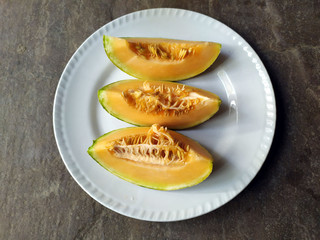 fresh healthy yellow fruit bite put in a white plate