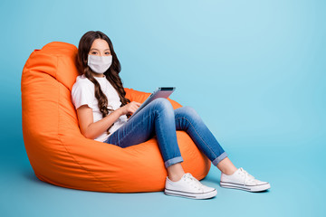 Portrait of her she nice attractive healthy wavy-haired girl sitting in chair using reading e-book...