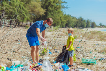 Volunteer blue face mask forest sand beach. Son helps father hold black bag for pick up garbage. Problem spilled rubbish trash planet pollution environmental protection. Natural children education