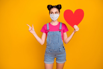 Portrait of her she nice attractive girl holding in hand paper heart wearing safety mask showing copy space mers cov infection insurance isolated bright vivid shine vibrant yellow color background