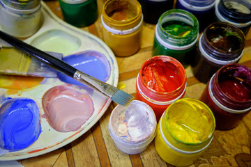 Paintbrush artist palette and multi colored gouache