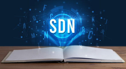 SDN inscription coming out from an open book, digital technology concept