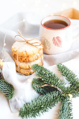 Composition of fresh cookies and fir branches on a wooden tray. Christmas concept. Close up.